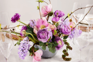 Lilac and pink spring floral centrepiece in ceramic vase, wedding table styling